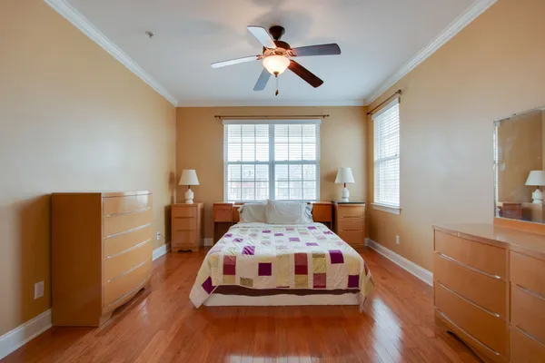 a bedroom with a bed and a chandelier