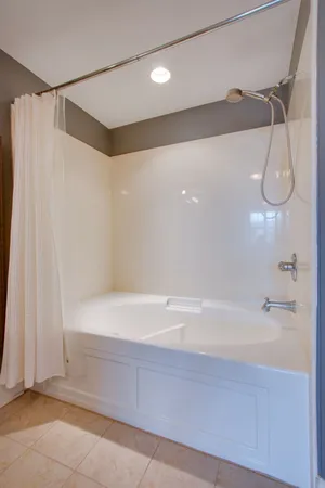 a bathroom with a shower and a bath tub