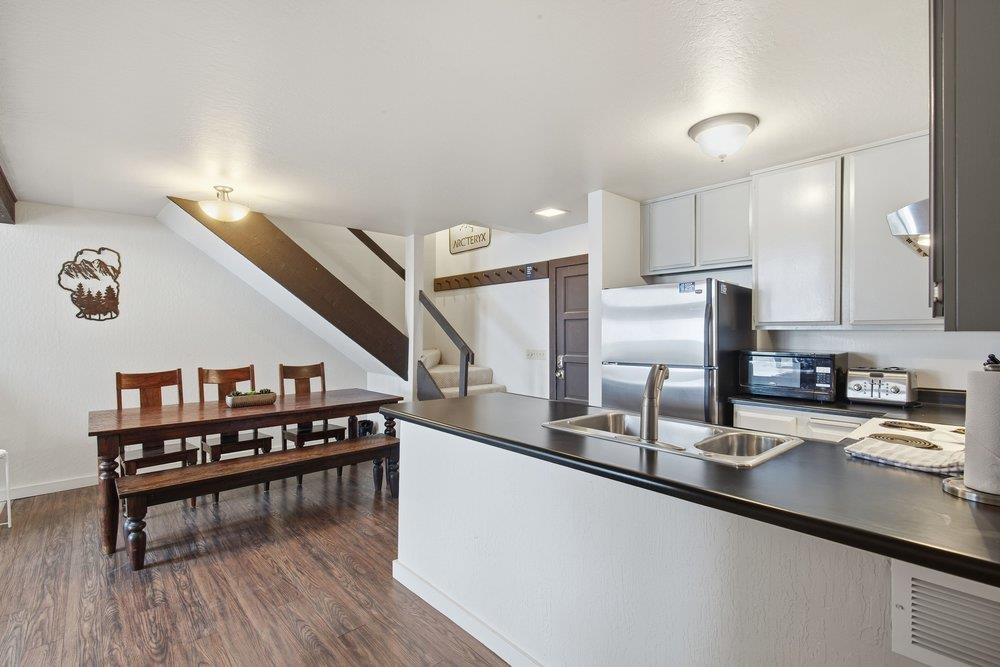 2090 Chalet Road, Unit 16 Alpine Meadows, CA 96146 - Photo 6 of 20 a kitchen with stainless steel appliances granite countertop a sink a stove and a wooden floors