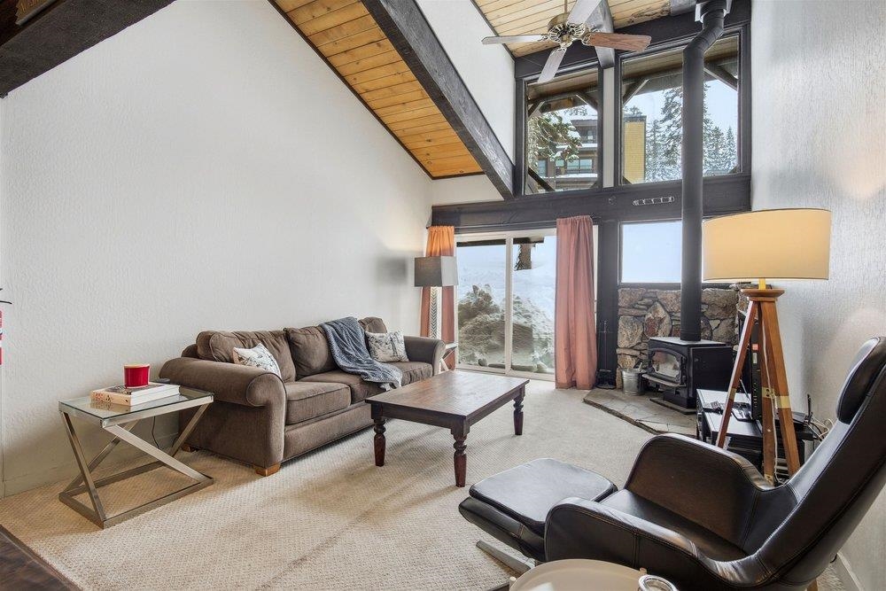 2090 Chalet Road, Unit 16 Alpine Meadows, CA 96146 - Photo 9 of 20 a living room with furniture a fireplace and a large window