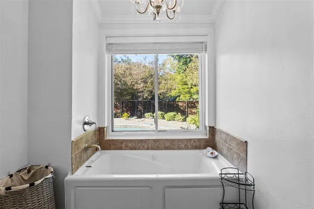 a bathroom with a bathtub and window