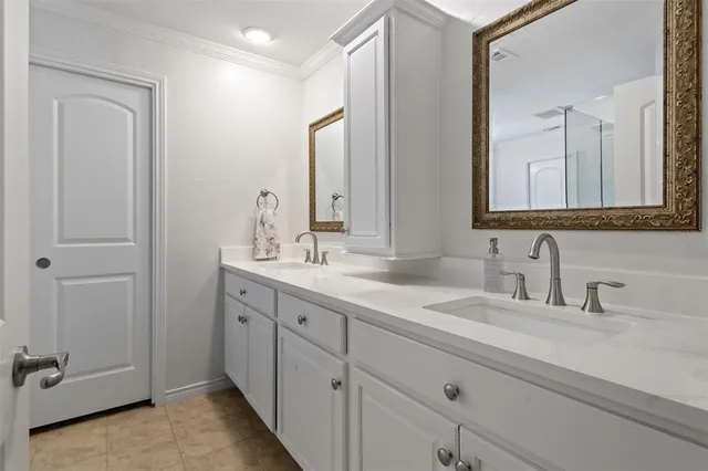 a bathroom with double sink and a mirror
