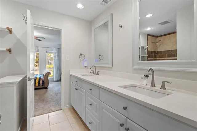a spacious bathroom with a double vanity sink double and mirror