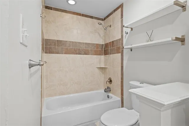 a bathroom with a shower a toilet and a bathtub
