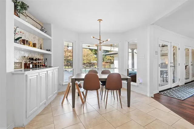 a view of a dining room with furniture and chandelier