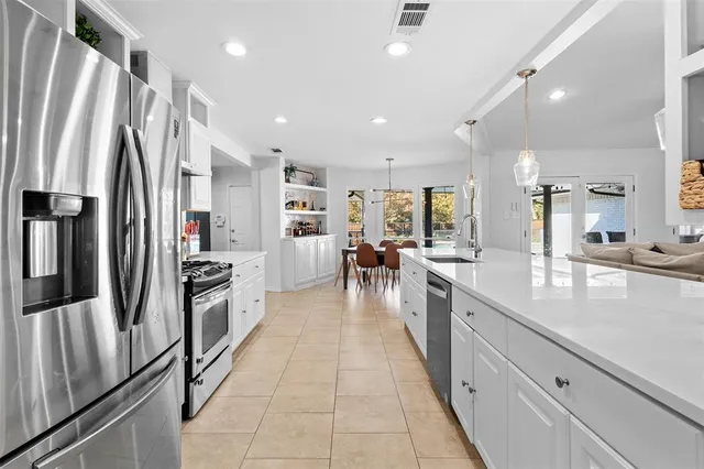 a large kitchen with stainless steel appliances lots of counter space and a refrigerator