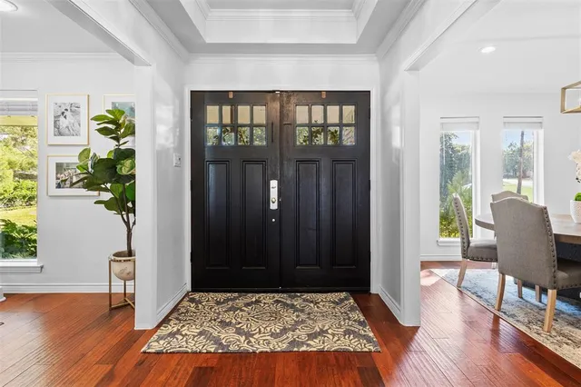 a living room with a rug and wooden floor