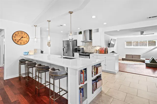 a kitchen with a table chairs stove and cabinets