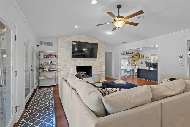 a living room with furniture a fireplace and a flat screen tv