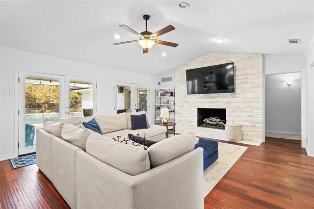 a living room with furniture a fireplace and a flat screen tv