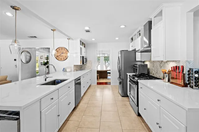 a kitchen with a refrigerator and a sink