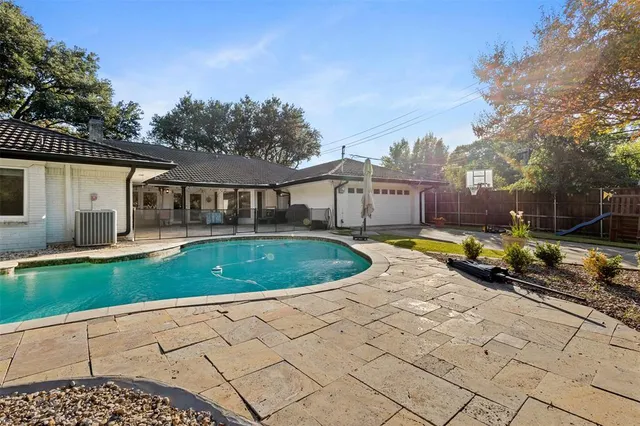 a view of a house with a backyard and sitting area