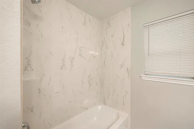 a bathroom with a white shower curtain