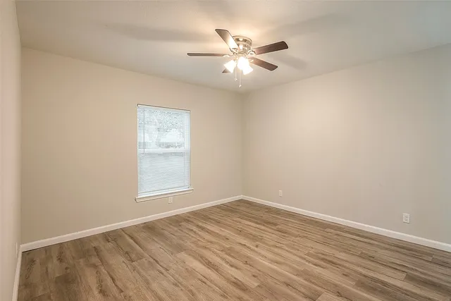 wooden floor in an empty room with a window