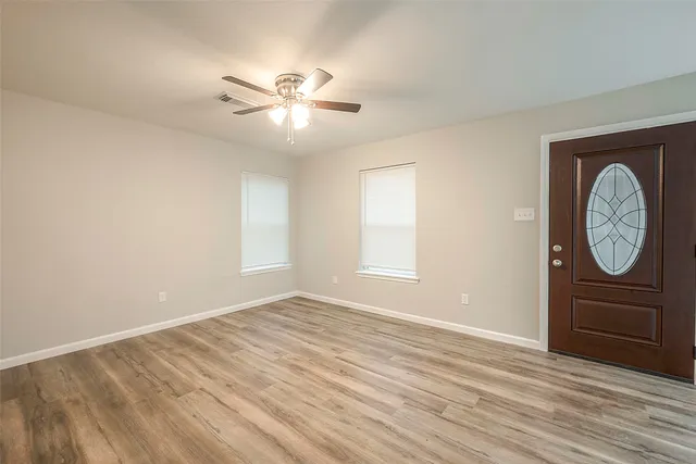 a view of a livingroom with a hardwood floor and a ceiling fan