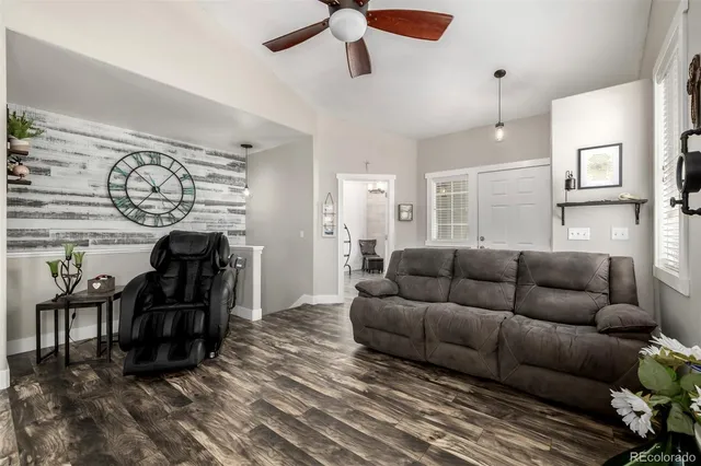 a living room with furniture and wooden floor