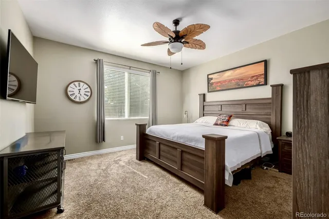 a bedroom with a large bed and a tv