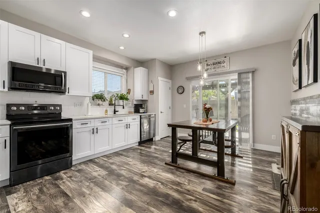 a kitchen with microwave a stove and furniture