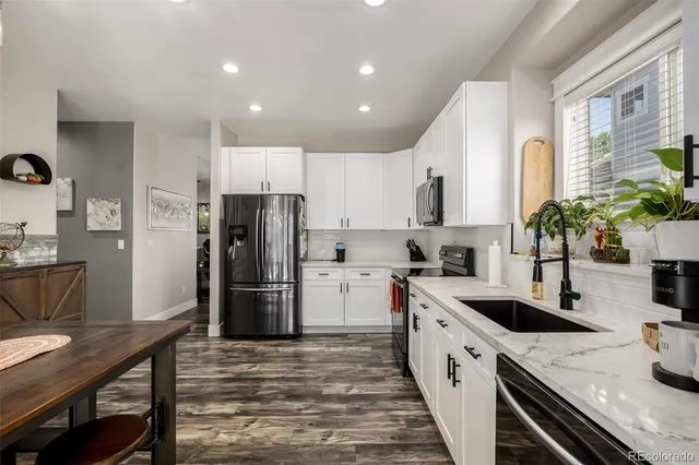 a kitchen with a refrigerator and a sink