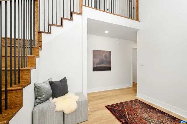 a view of a bedroom with furniture and wooden floor