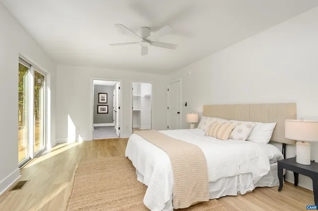 a spacious bedroom with a bed and a table