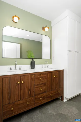a bathroom with a double vanity sink and mirror