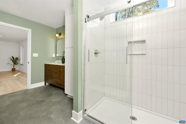 a bathroom with a shower and a sink