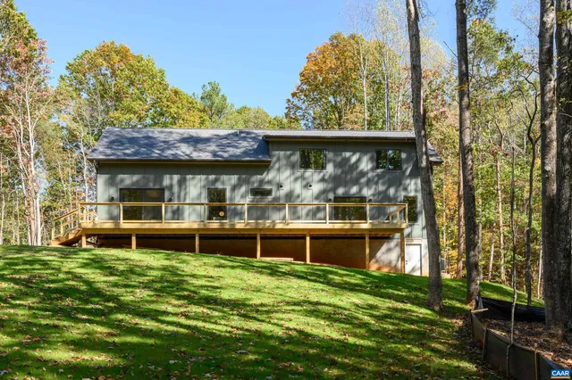 a view of a house with a yard table and chairs
