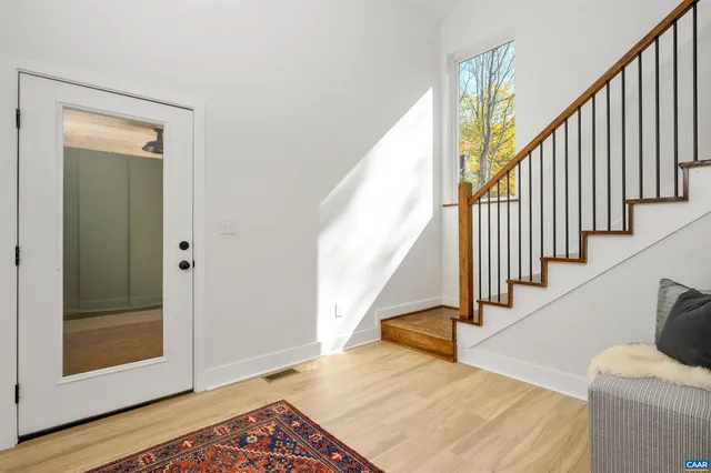 a view of entryway and hall with wooden floor