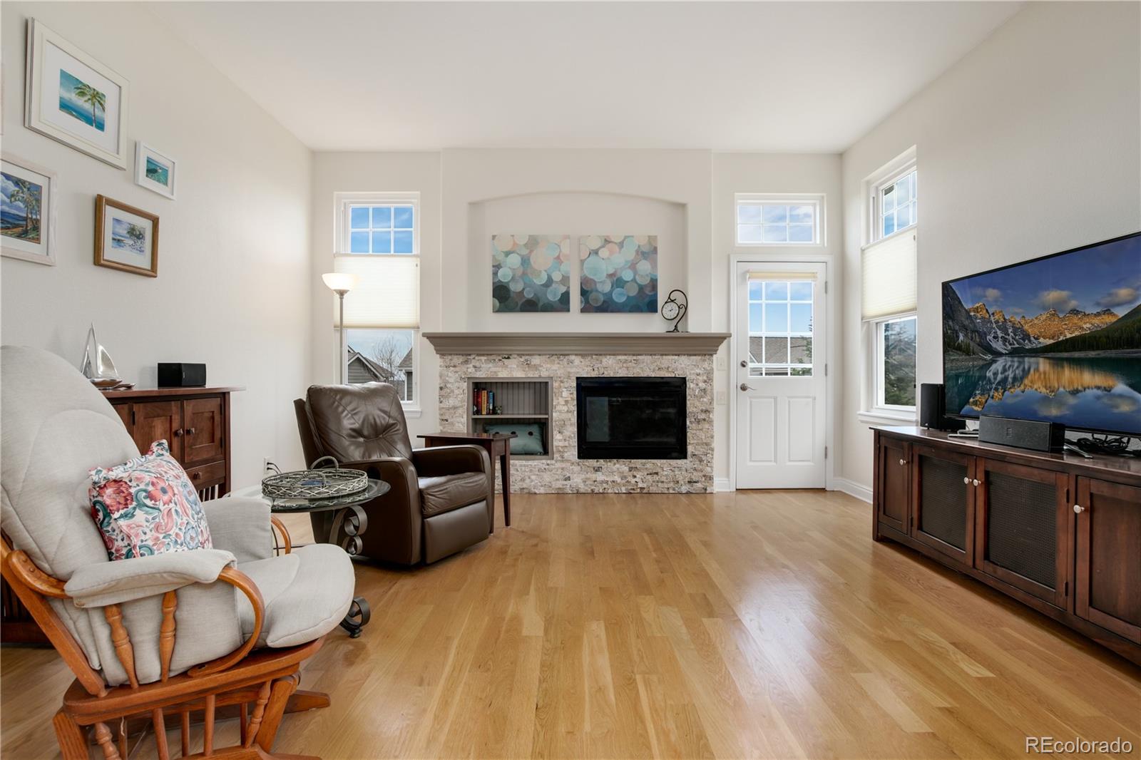 3946 Mallard Street Highlands Ranch, CO 80126 - Photo 14 of 40 a living room with furniture and a fireplace