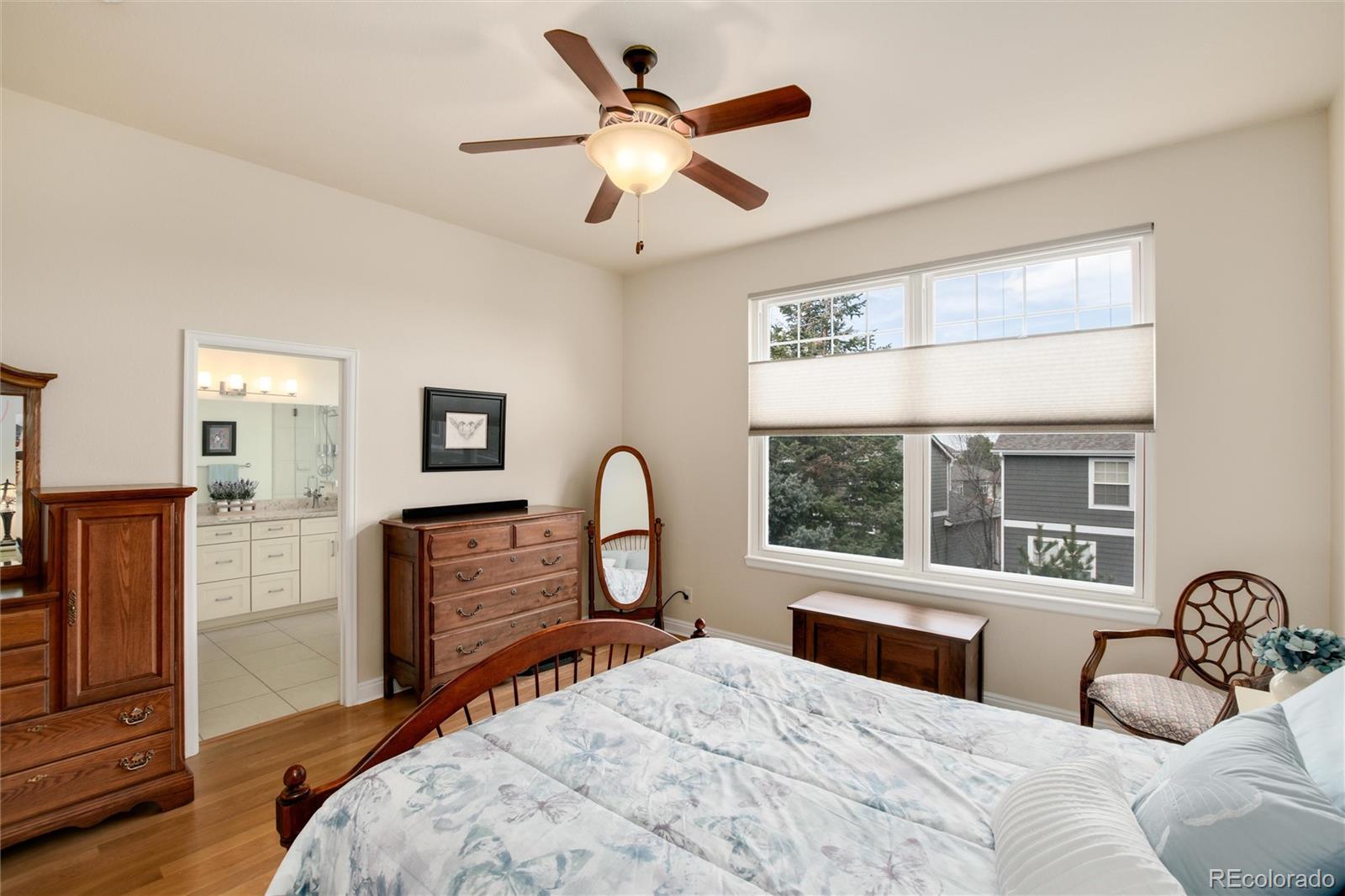 3946 Mallard Street Highlands Ranch, CO 80126 - Photo 17 of 40 a bedroom with a large bed and a large window
