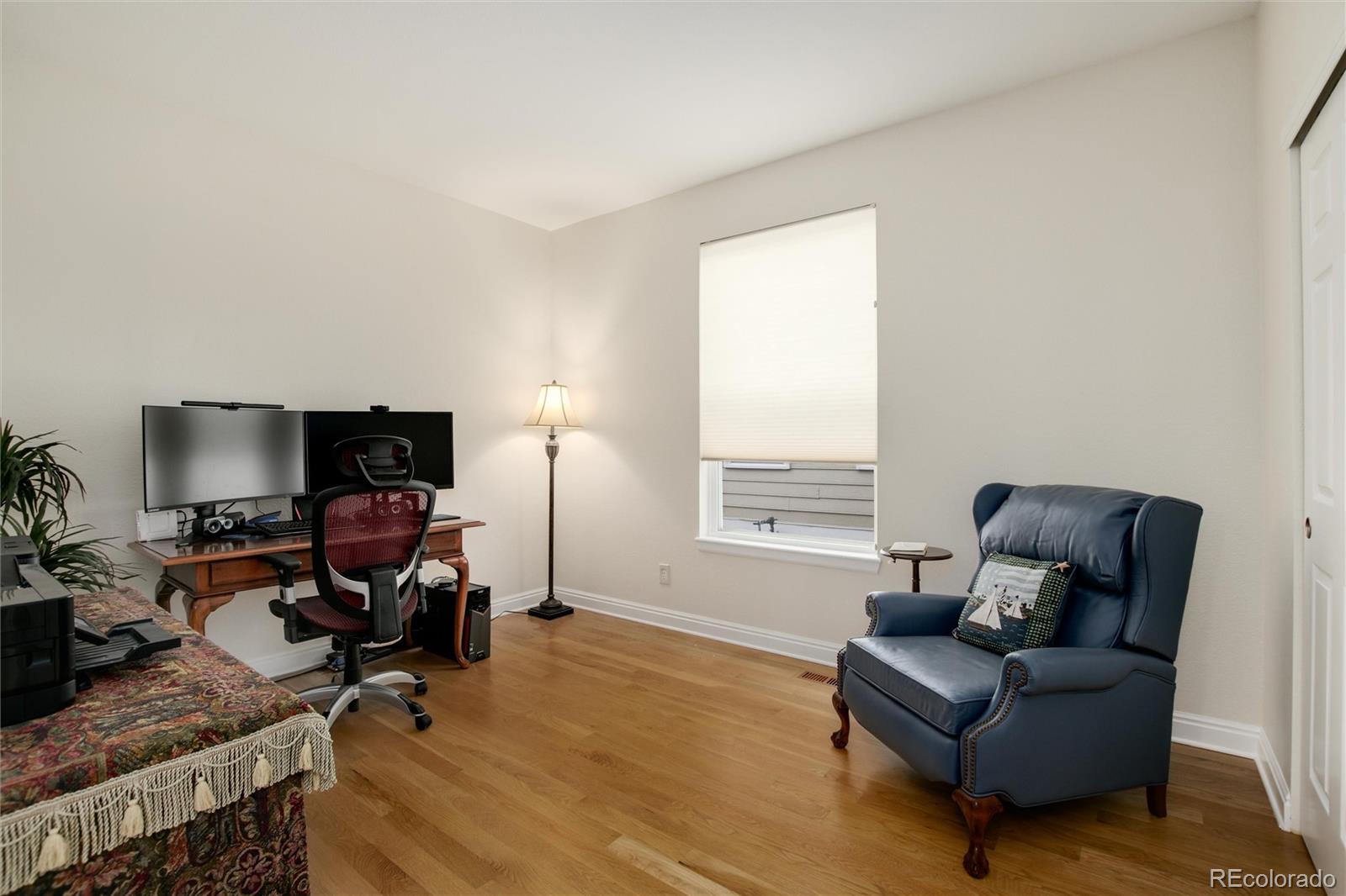 3946 Mallard Street Highlands Ranch, CO 80126 - Photo 20 of 40 a living room with furniture and a flat screen tv