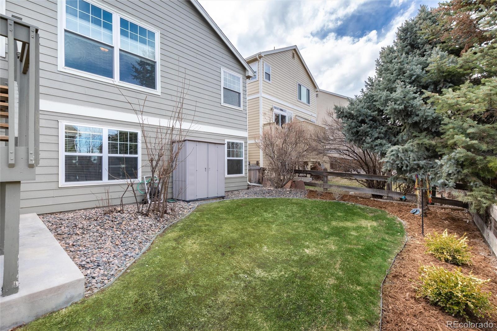3946 Mallard Street Highlands Ranch, CO 80126 - Photo 33 of 40 a front view of a house with garden