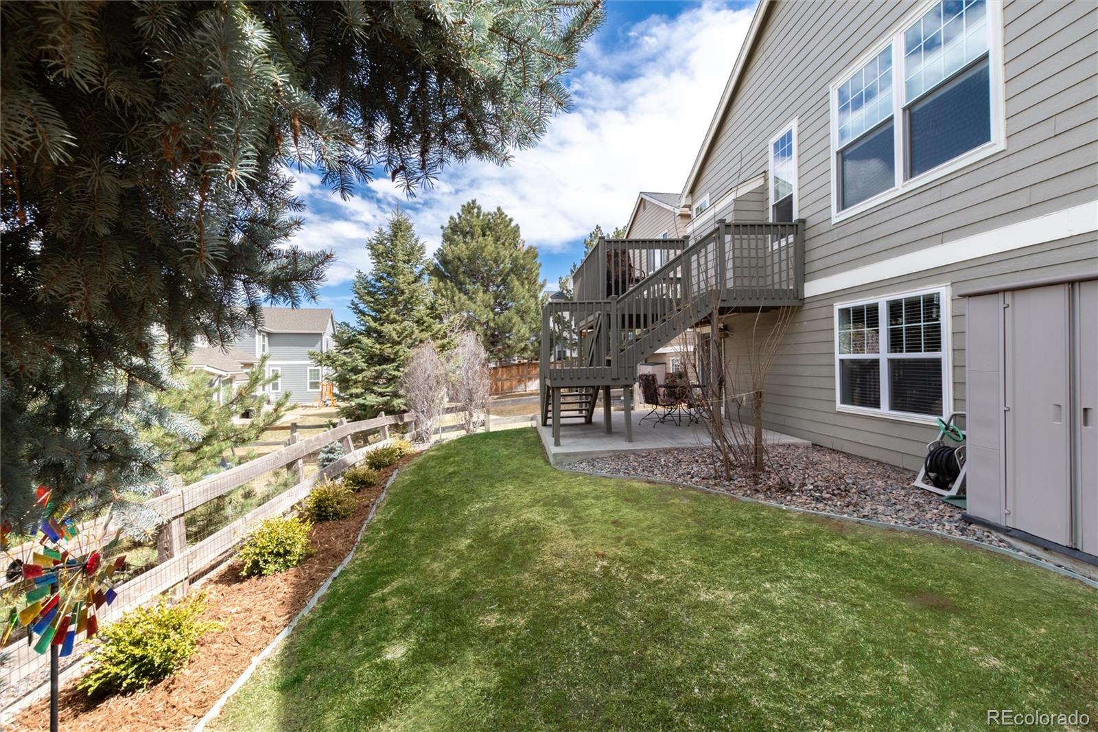3946 Mallard Street Highlands Ranch, CO 80126 - Photo 34 of 40 a backyard of a house with table and chairs