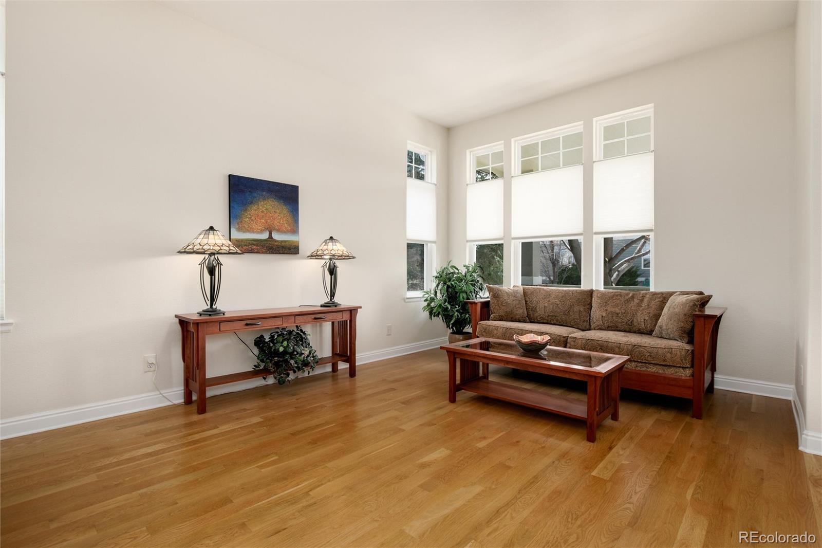 3946 Mallard Street Highlands Ranch, CO 80126 - Photo 4 of 40 a living room with furniture and a flat screen tv