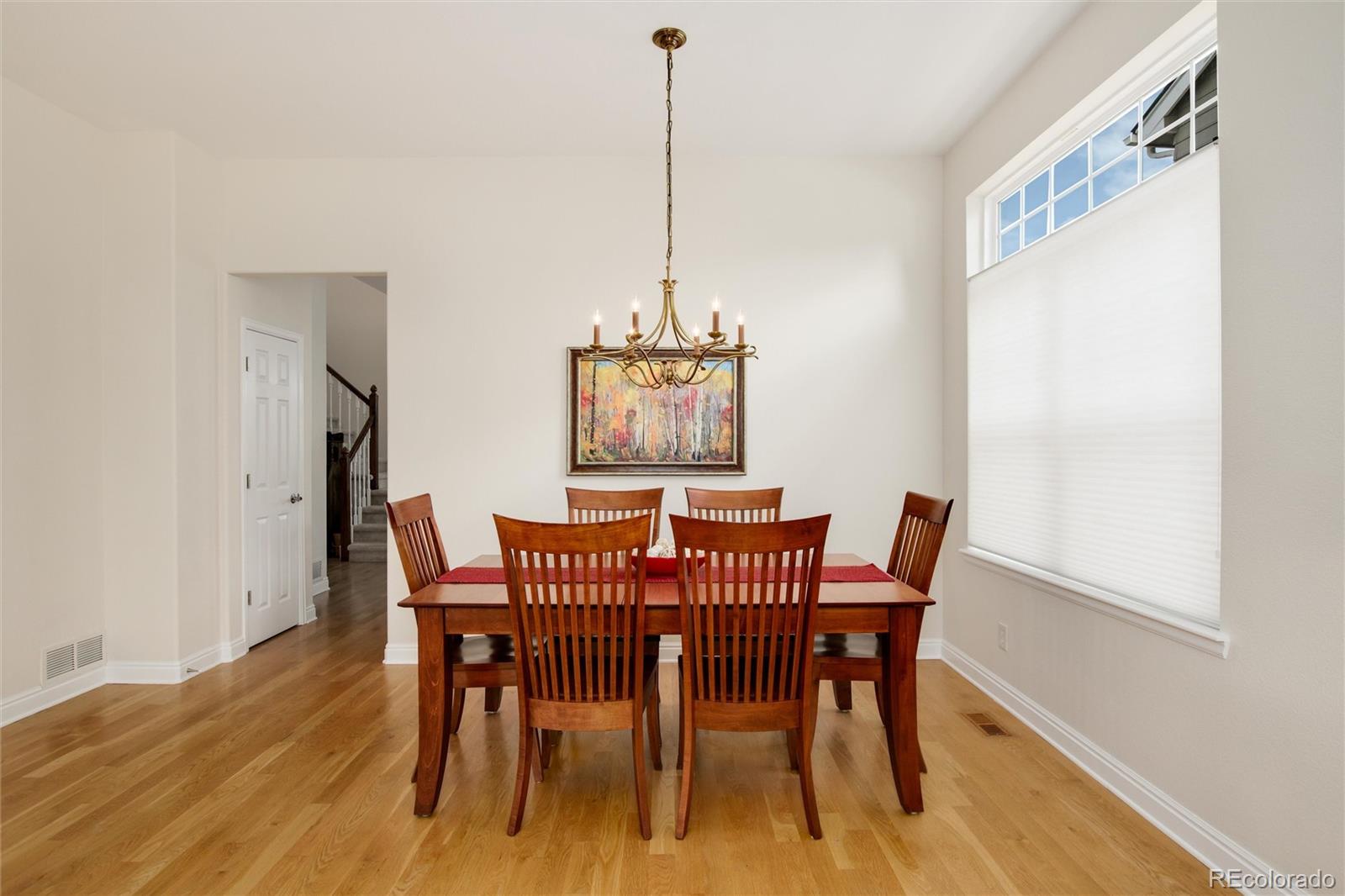 3946 Mallard Street Highlands Ranch, CO 80126 - Photo 6 of 40 a view of a dining room with furniture window and wooden floor
