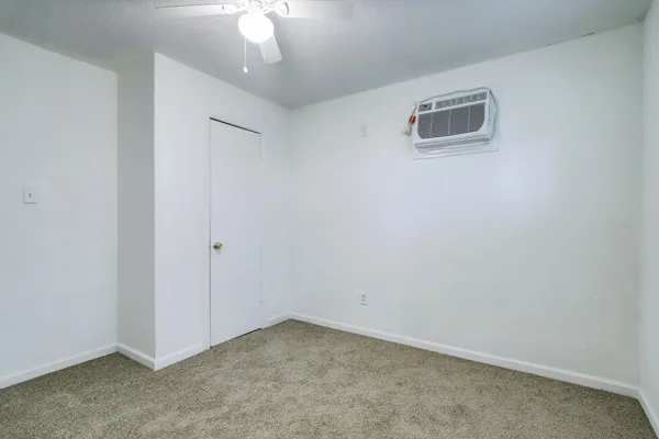 an empty room with a ceiling fan