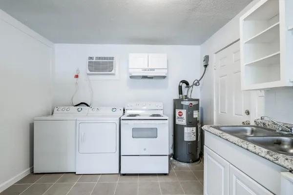 a kitchen with cabinets appliances and a sink