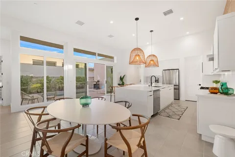 a view of a kitchen with a sink and a large window
