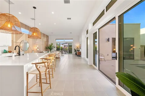 a view of a chairs and table in patio with a small yard