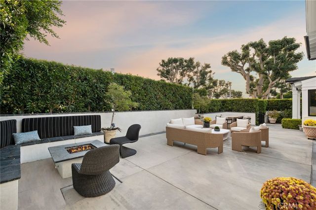 a view of backyard with seating space and trees