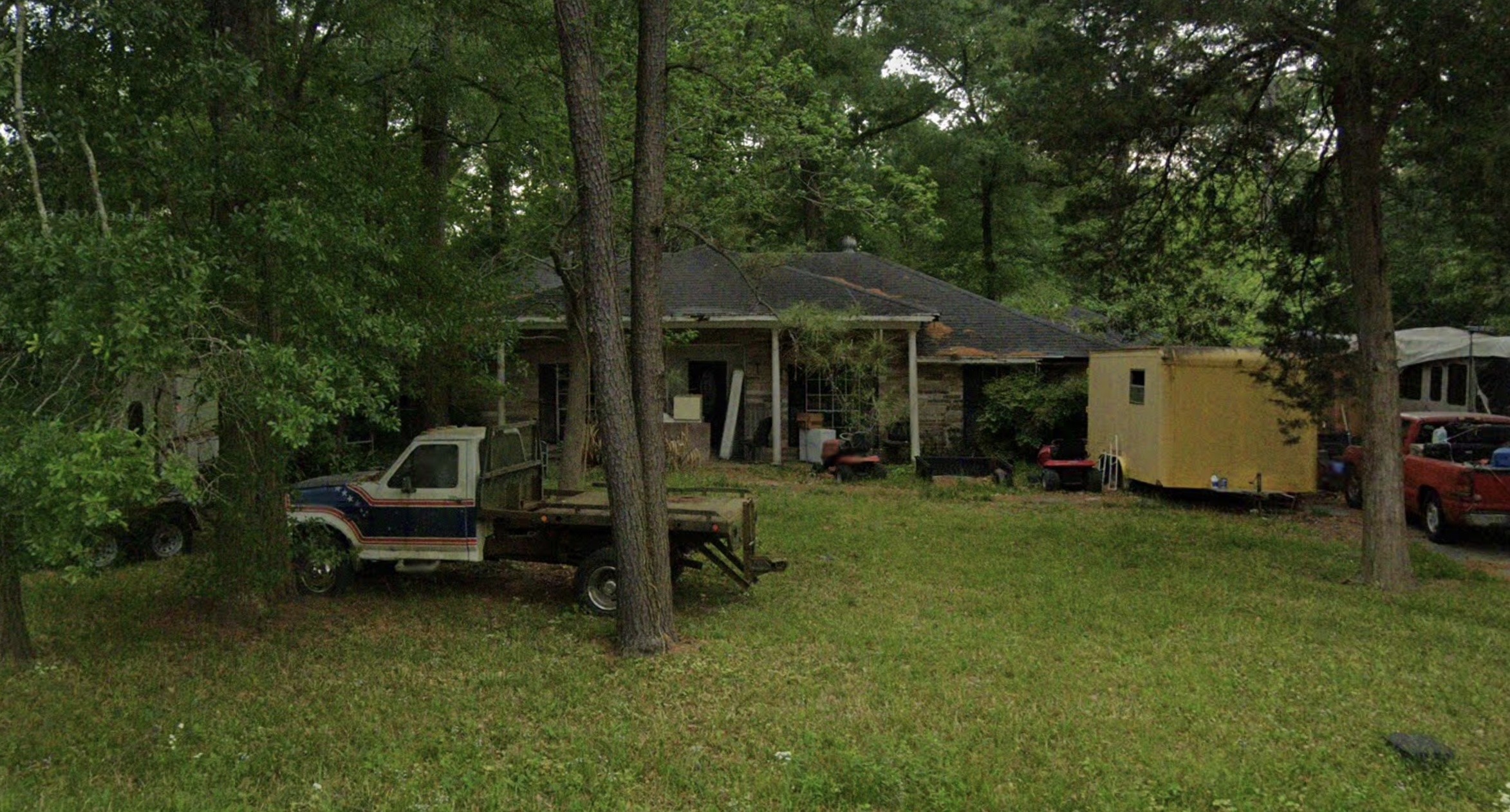 a view of a chair and table in backyard of the house