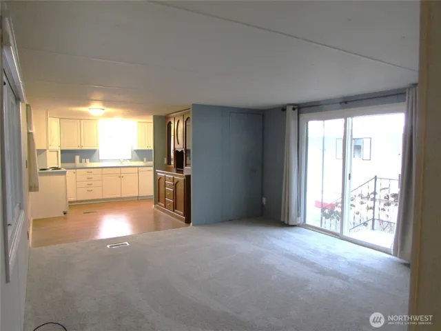 a view of an empty room with glass door