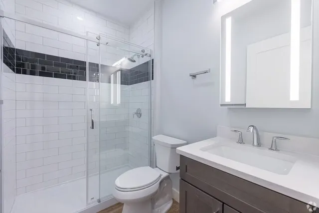 a bathroom with a sink toilet and shower