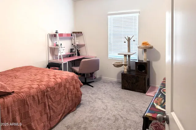 a bedroom with a bed wooden floor and a window