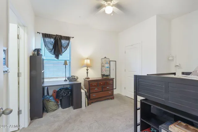 a view of a bedroom with a bed and cabinets