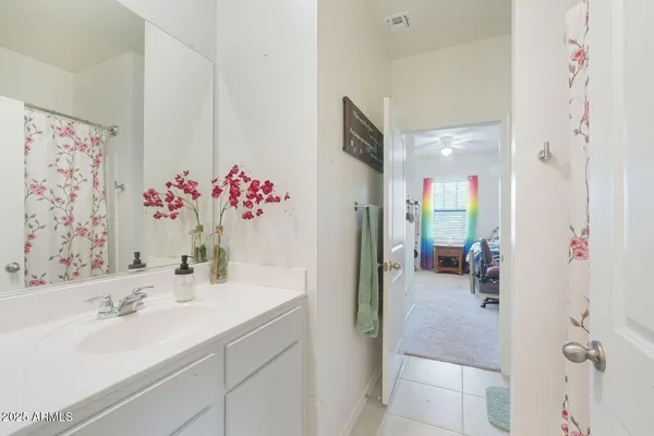 a bathroom with a sink vanity tub and shower