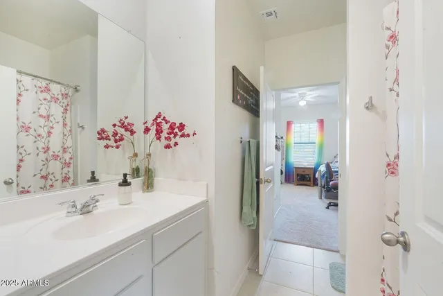 a bathroom with a sink vanity tub and shower