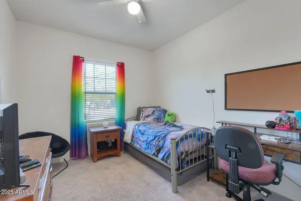 a bedroom with a bed chair and a window