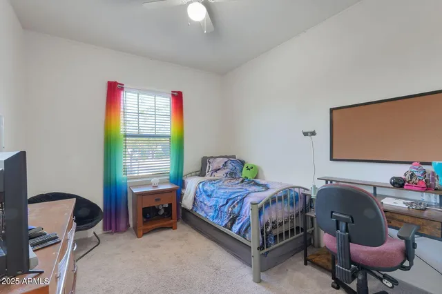 a bedroom with a bed chair and a window